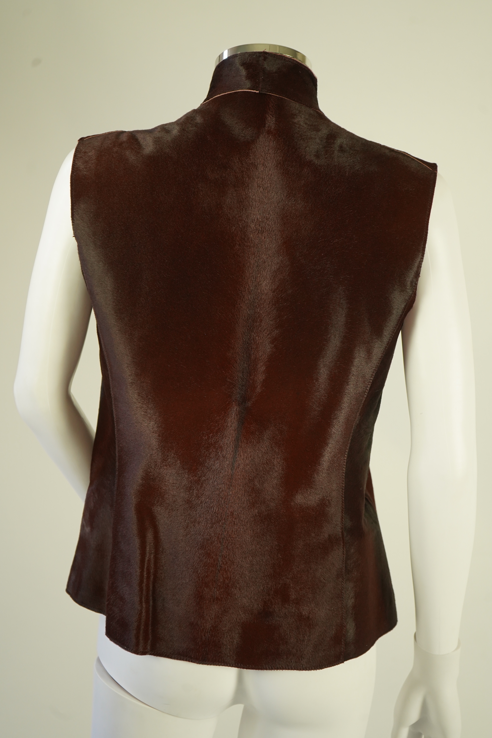 A lady's Jaeger brown ponyskin gilet with burgundy satin lining. UK 12-14